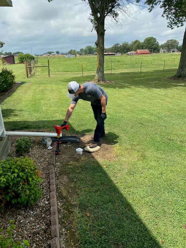 Trade Pro technician working outside a rural Northwest Arkansas home